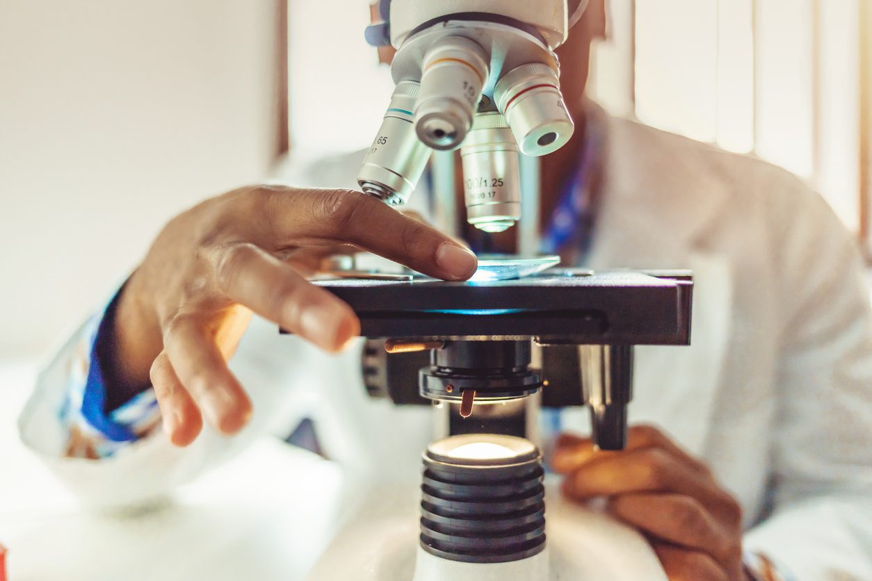 researcher using microscope