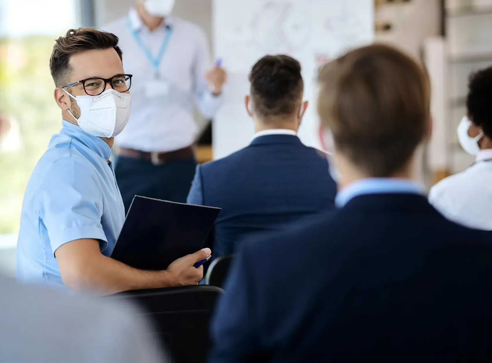 men in suits and np5 masks